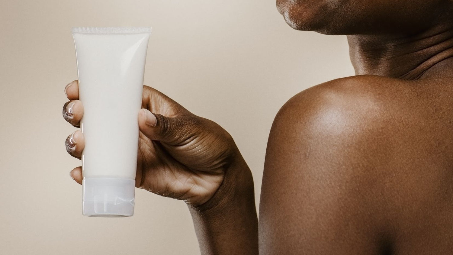 african woman holding natural skin care cosmetics